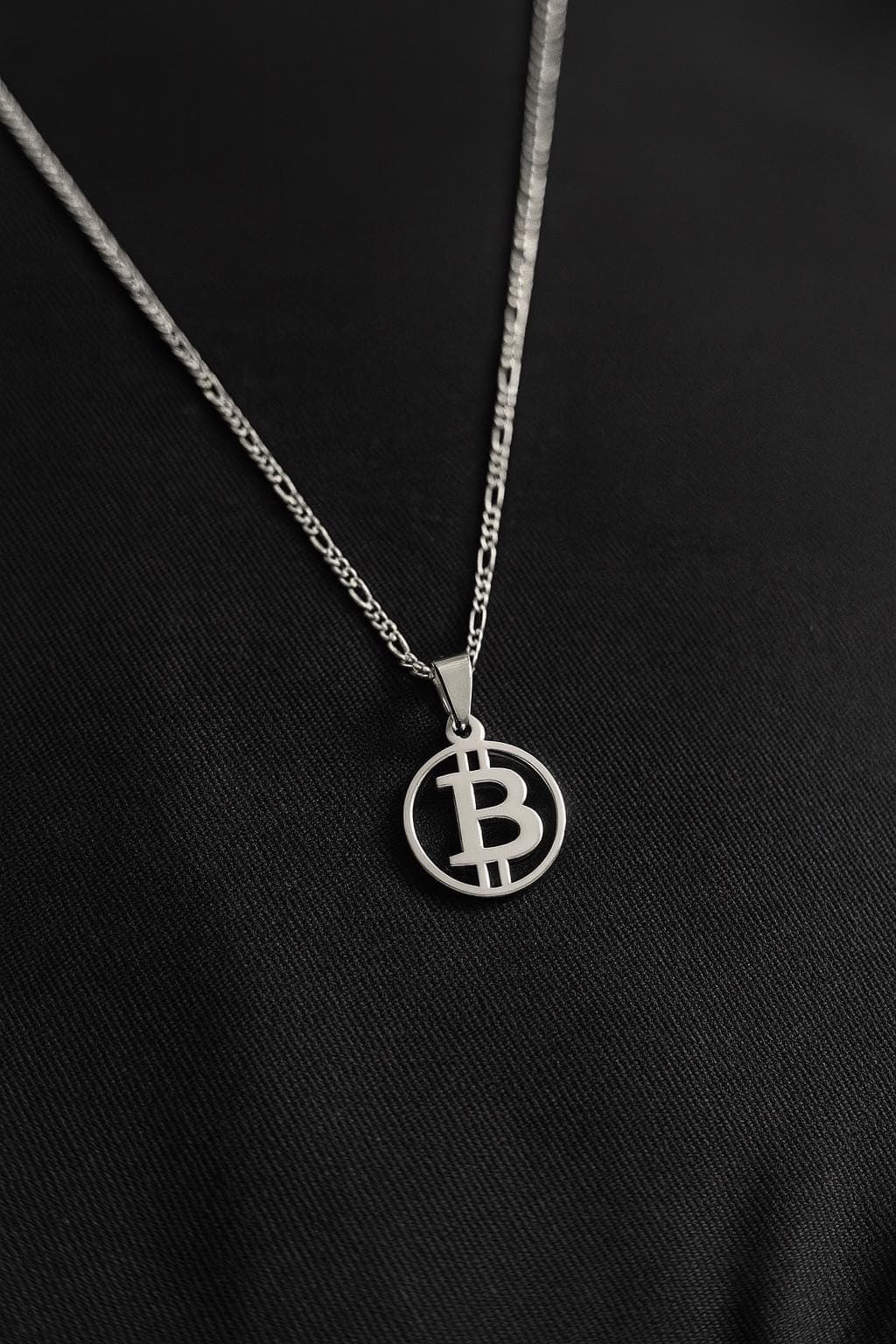 BTC Pendant in 925 silver on a figaro chain against black fabric